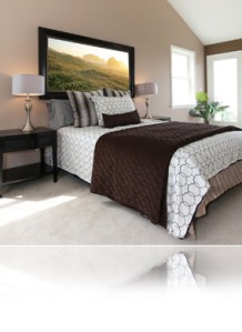 Modern brown and white bed with nightstands.